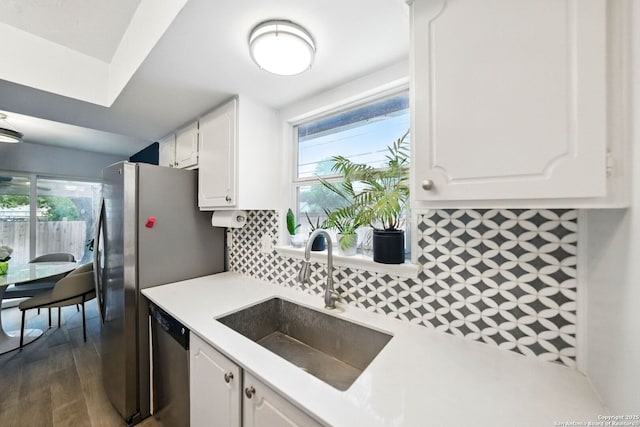 14201 Modesta Pl, San Antonio, TX 78247 - kitchen with a sink, dishwasher, white cabinetry, and light countertops