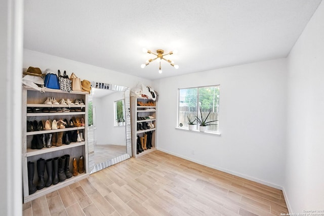 14201 Modesta Pl, San Antonio, TX 78247 - empty room featuring wood finished floors, a chandelier, and baseboards