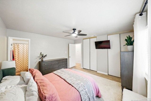 14201 Modesta Pl, San Antonio, TX 78247 - bedroom featuring wood finished floors, a ceiling fan, and two closets