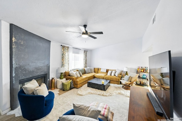 14201 Modesta Pl, San Antonio, TX 78247 - living area featuring a ceiling fan, a fireplace, and wood finished floors