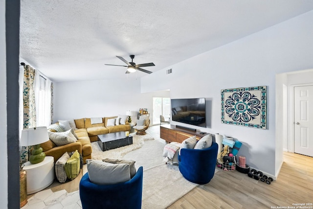 14201 Modesta Pl, San Antonio, TX 78247 - living room with a ceiling fan, wood finished floors, a textured ceiling, and baseboards