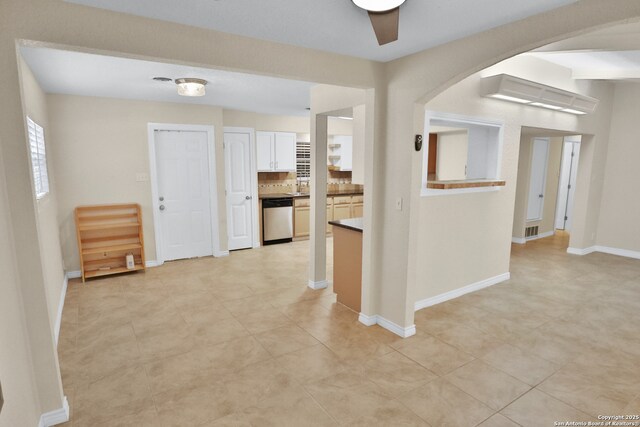230 Tammy Dr, San Antonio, TX 78216 - corridor featuring baseboards, light tile patterned floors, arched walkways, and a sink