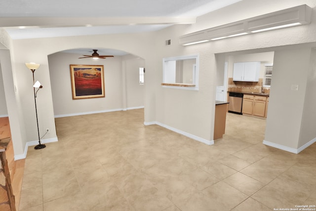 230 Tammy Dr, San Antonio, TX 78216 - unfurnished room featuring arched walkways, beamed ceiling, ceiling fan, baseboards, and light tile patterned flooring