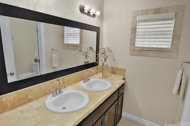 230 Tammy Dr, San Antonio, TX 78216 - bathroom with double vanity, toilet, and a textured wall