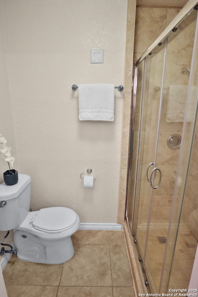 230 Tammy Dr, San Antonio, TX 78216 - full bath with toilet, tile patterned flooring, a shower stall, and baseboards
