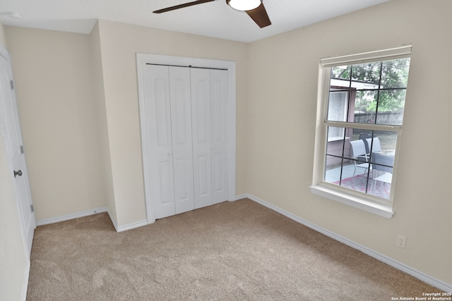 230 Tammy Dr, San Antonio, TX 78216 - unfurnished bedroom featuring carpet floors, a closet, baseboards, and a ceiling fan