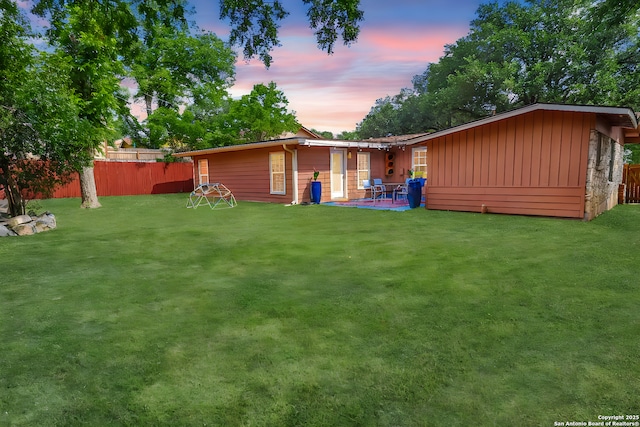 230 Tammy Dr, San Antonio, TX 78216 - back of house at dusk featuring board and batten siding and a patio