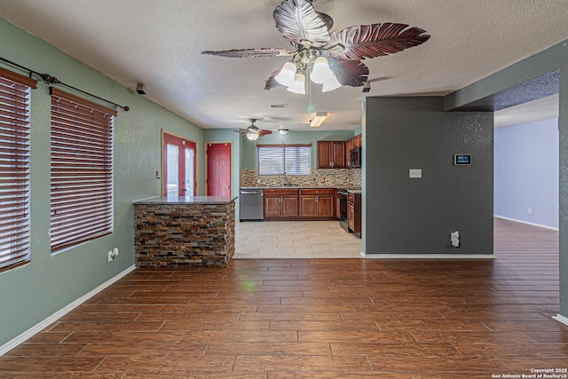 7202 Archers Coach, San Antonio, TX 78244 - kitchen with stainless steel dishwasher, light wood-style floors, ceiling fan, a textured ceiling, and backsplash