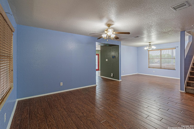 7202 Archers Coach, San Antonio, TX 78244 - empty room with stairway, wood finished floors, a ceiling fan, a textured ceiling, and a chandelier