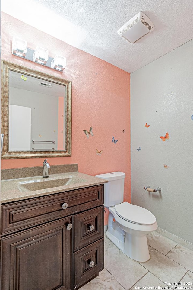 7202 Archers Coach, San Antonio, TX 78244 - bathroom featuring vanity, toilet, a textured ceiling, tile patterned flooring, and a textured wall