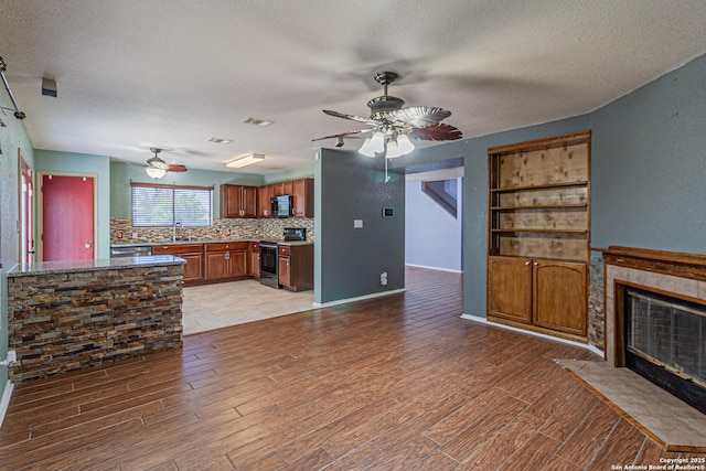 7202 Archers Coach, San Antonio, TX 78244 - unfurnished living room with a ceiling fan, a sink, a textured ceiling, and light wood finished floors