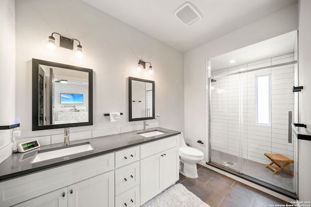 1226 Wyoming Unit 201, San Antonio, TX 78203 - bathroom featuring double vanity, a shower stall, toilet, and tile patterned flooring