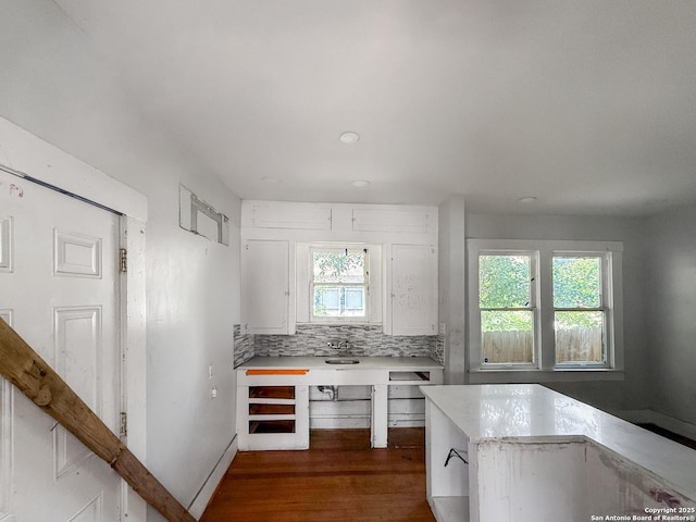 102 Benita, San Antonio, TX 78210 - kitchen featuring dark wood finished floors, light countertops, plenty of natural light, and backsplash