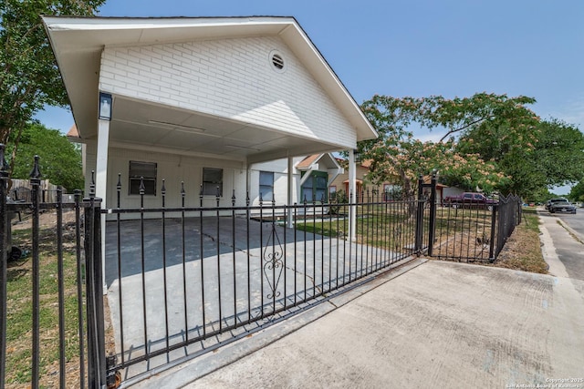4335 Misty Spgs, San Antonio, TX 78244 - view of front facade featuring brick siding, a fenced front yard, concrete driveway, and a carport