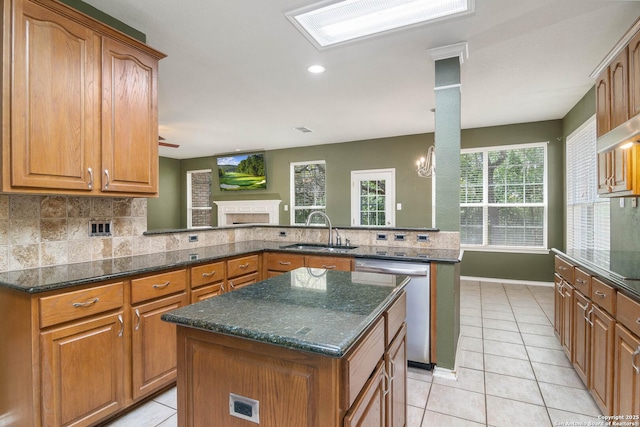 2610 Plum Holw, San Antonio, TX 78258 - kitchen featuring a sink, dishwasher, tasteful backsplash, light tile patterned floors, and brown cabinetry