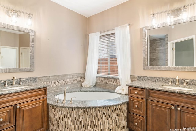 2610 Plum Holw, San Antonio, TX 78258 - full bathroom with two vanities and a garden tub