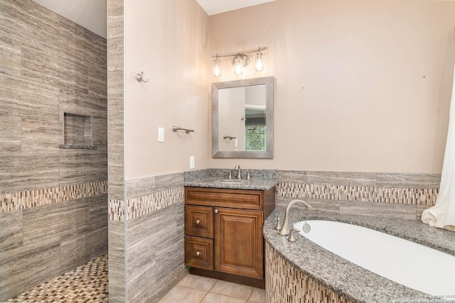 2610 Plum Holw, San Antonio, TX 78258 - full bath with tile patterned floors, a garden tub, vanity, tile walls, and tiled shower