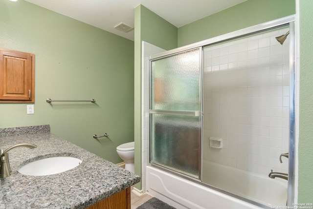 2610 Plum Holw, San Antonio, TX 78258 - bathroom with vanity, toilet, bath / shower combo with glass door, and tile patterned floors