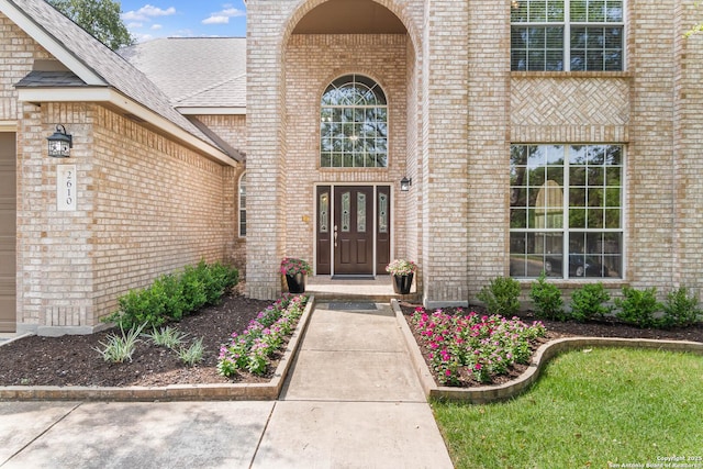 2610 Plum Holw, San Antonio, TX 78258 - view of exterior entry featuring brick siding and a shingled roof