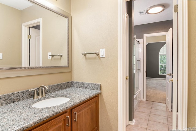 2610 Plum Holw, San Antonio, TX 78258 - full bathroom featuring tile patterned floors, vanity, and combined bath / shower with glass door