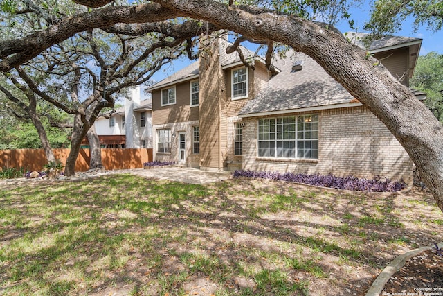 2610 Plum Holw, San Antonio, TX 78258 - rear view of property featuring a patio area, a chimney, and roof with shingles
