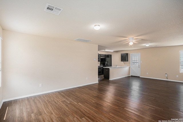 7406 Snapdragon Ct, Converse, TX 78109 - unfurnished living room featuring a ceiling fan, dark wood-style flooring, and baseboards