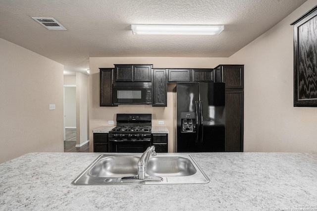 7406 Snapdragon Ct, Converse, TX 78109 - kitchen with black appliances, light countertops, a sink, and a textured ceiling
