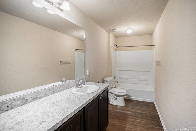 7406 Snapdragon Ct, Converse, TX 78109 - full bathroom with toilet, vanity, wood finished floors, tub / shower combination, and a textured ceiling