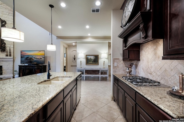 26019 Red Heron, San Antonio, TX 78261 - kitchen with a sink, appliances with stainless steel finishes, backsplash, light stone countertops, and ornamental molding