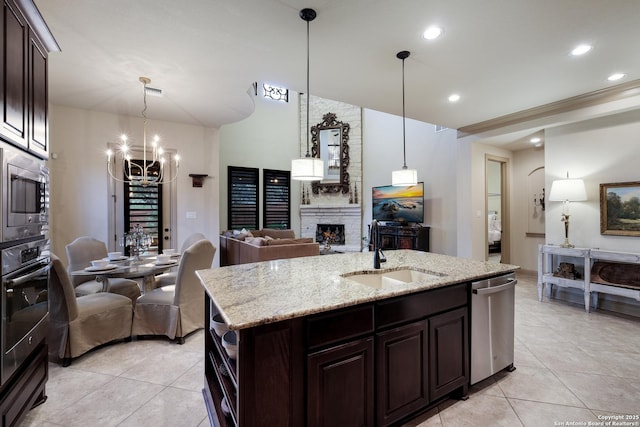 26019 Red Heron, San Antonio, TX 78261 - kitchen with a sink, stainless steel appliances, a fireplace, dark brown cabinetry, and light tile patterned flooring