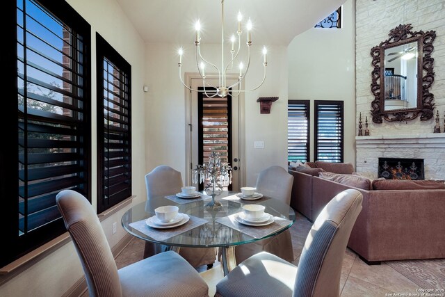 26019 Red Heron, San Antonio, TX 78261 - tiled dining space featuring a chandelier and a fireplace