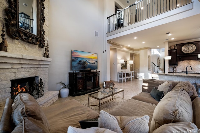 26019 Red Heron, San Antonio, TX 78261 - living area with a fireplace, a towering ceiling, stairway, recessed lighting, and light tile patterned floors