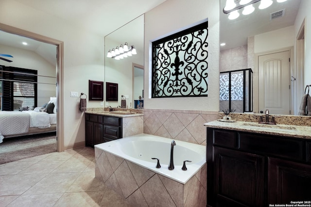 26019 Red Heron, San Antonio, TX 78261 - ensuite bathroom featuring a bath, two vanities, a shower stall, and tile patterned flooring