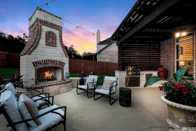 26019 Red Heron, San Antonio, TX 78261 - fenced backyard with a lit fireplace and a patio area
