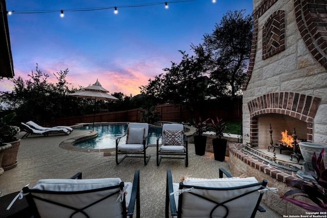 26019 Red Heron, San Antonio, TX 78261 - view of pool featuring an outdoor brick fireplace, a patio area, and a fenced backyard