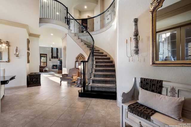 26019 Red Heron, San Antonio, TX 78261 - entryway featuring stairway, tile patterned flooring, a lit fireplace, and a high ceiling