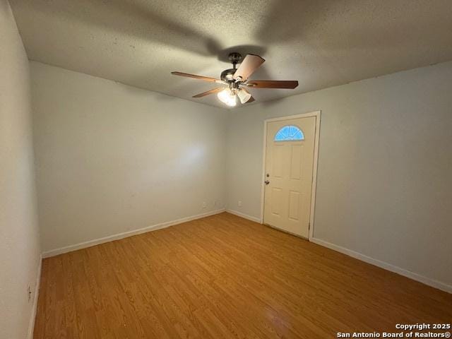 2854 Cherry Fld, San Antonio, TX 78245 - empty room with a ceiling fan, light wood-type flooring, baseboards, and a textured ceiling