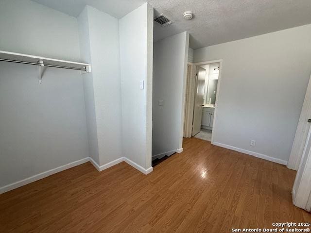2854 Cherry Fld, San Antonio, TX 78245 - unfurnished bedroom featuring baseboards and wood finished floors