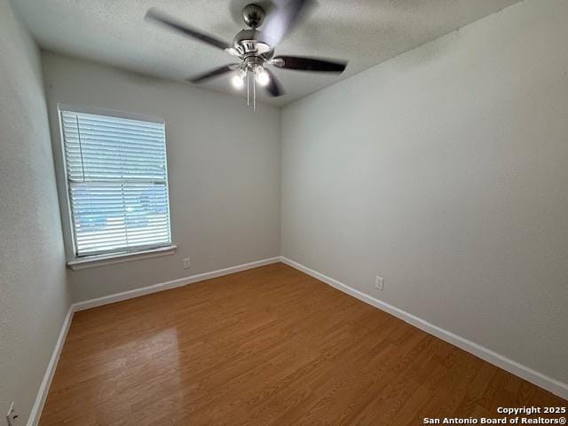 2854 Cherry Fld, San Antonio, TX 78245 - spare room featuring wood finished floors, baseboards, and a ceiling fan