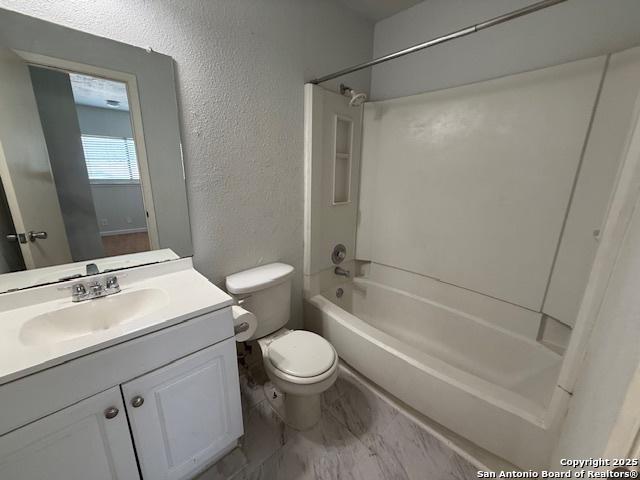 2854 Cherry Fld, San Antonio, TX 78245 - full bath with a textured wall, tub / shower combination, toilet, vanity, and marble finish flooring