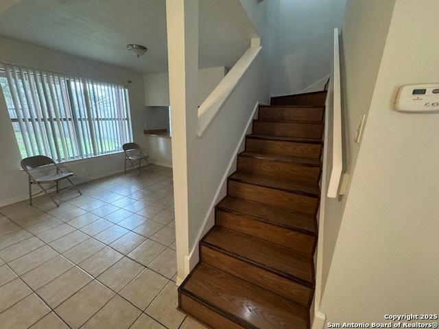 2854 Cherry Fld, San Antonio, TX 78245 - staircase with tile patterned floors and baseboards