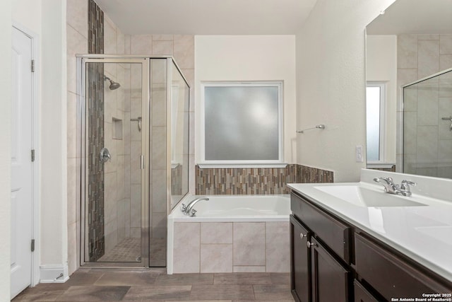 13106 Welder, San Antonio, TX 78253 - full bathroom featuring a stall shower, a garden tub, vanity, and wood finished floors