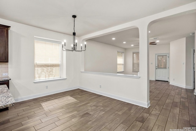 13106 Welder, San Antonio, TX 78253 - unfurnished dining area with dark wood-style flooring, a chandelier, baseboards, and recessed lighting
