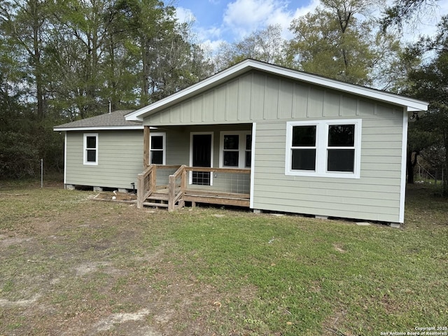 390 W Park St, Vidor, TX 77662 - back of property with a lawn and board and batten siding