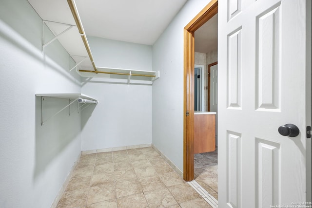27026 Wooded Acres, San Antonio, TX 78260 - walk in closet featuring stone finish floors