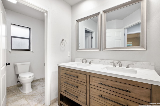 27026 Wooded Acres, San Antonio, TX 78260 - full bathroom with double vanity, toilet, and baseboards