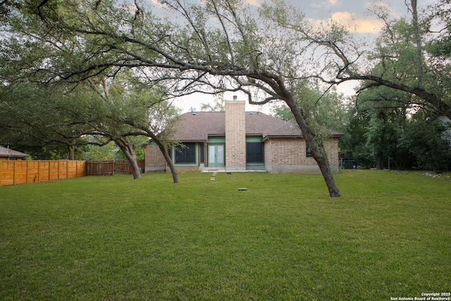 27026 Wooded Acres, San Antonio, TX 78260 - view of front facade with a chimney, roof with shingles, and brick siding