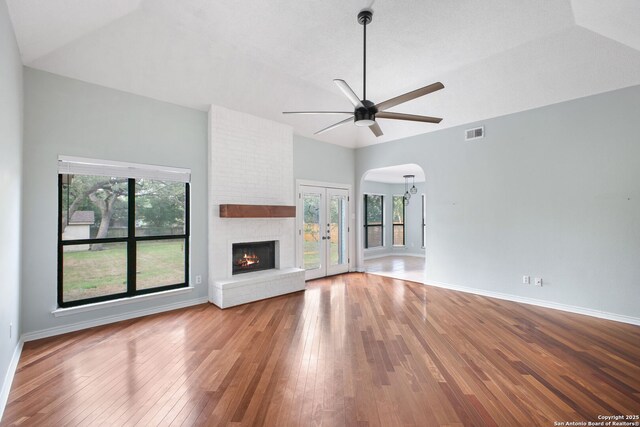 27026 Wooded Acres, San Antonio, TX 78260 - unfurnished living room with arched walkways, wood-type flooring, ceiling fan, healthy amount of natural light, and high vaulted ceiling