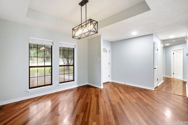 27026 Wooded Acres, San Antonio, TX 78260 - unfurnished room featuring wood-type flooring, baseboards, recessed lighting, and a chandelier