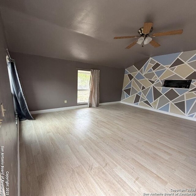 28 28th, Lakehills, TX 78063 - empty room featuring ceiling fan, wood finished floors, and baseboards